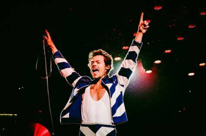 Harry Styles performing live on the stage.