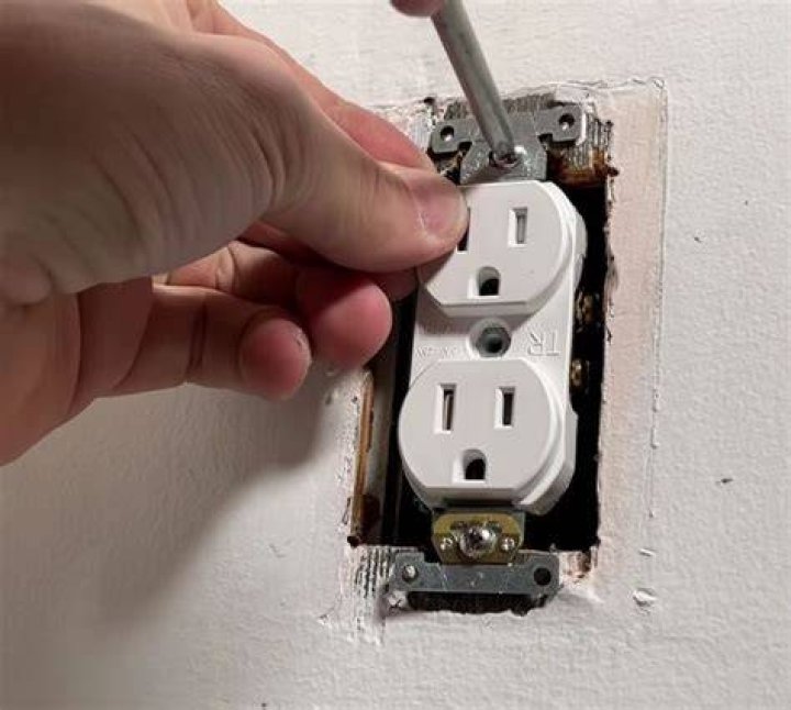 How do you fix a loose electrical outlet box?