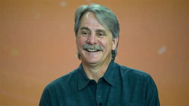 Jeff Foxworthy posing with his John Deere tractors.