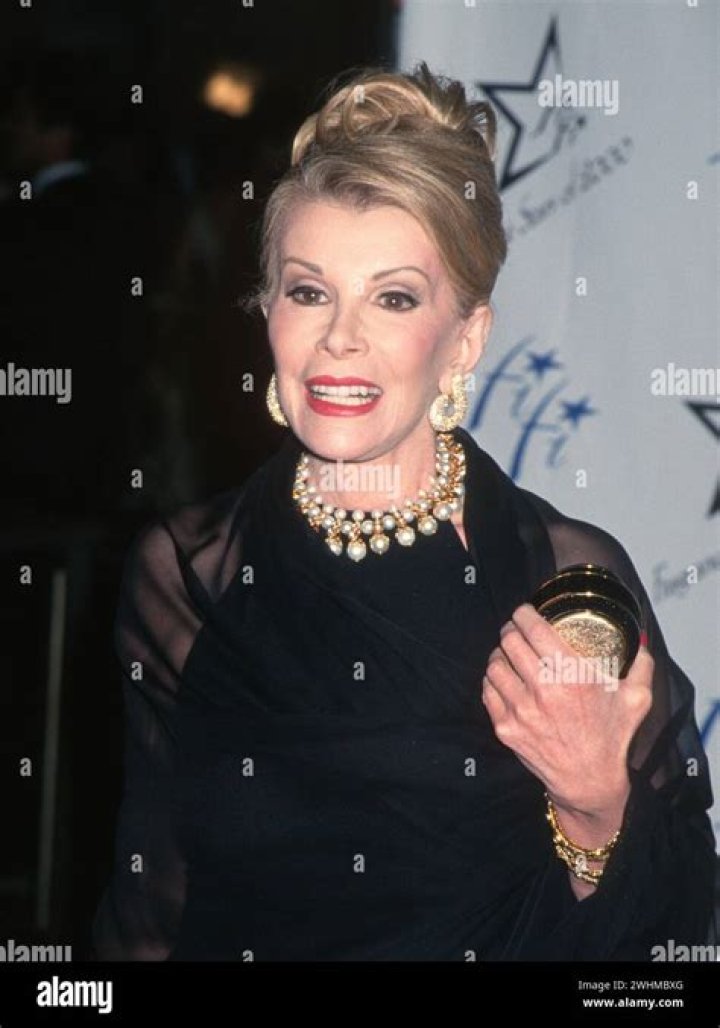 Joan Rivers gathers a small crowd in Beverly Hills as she shoots with a small camera crew. Joan gets a lot of attention from the passers by on Rodeo Drive. She sits on the hood of a posh sports car before doing an interview with its owner. Photo via Splashnews