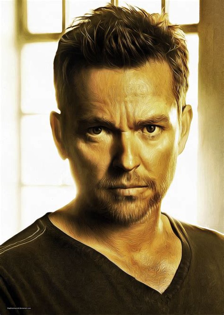 Jonathan Scarfe wearing black t-shirt with a short black hair.