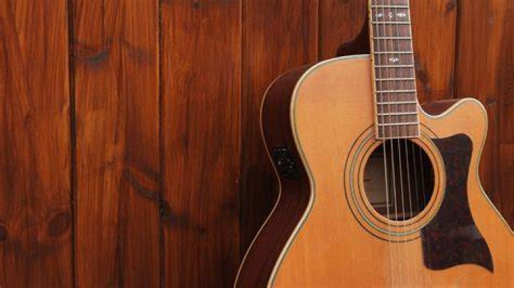 The guitar has brown color on the edges with some designs in the middle.