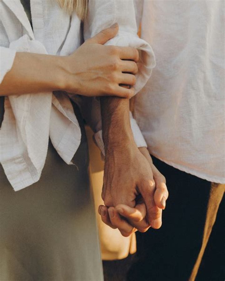 The romantic Leopold couple holding hands on their wedding day.