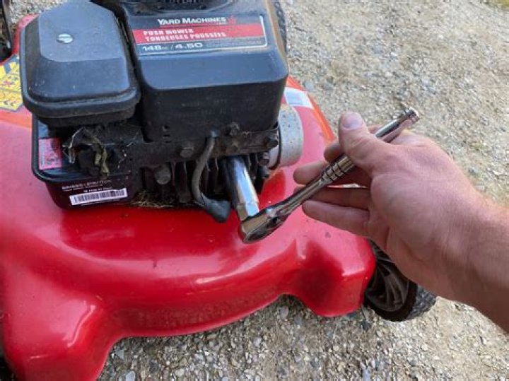 Where is the spark plug on a lawn mower?
